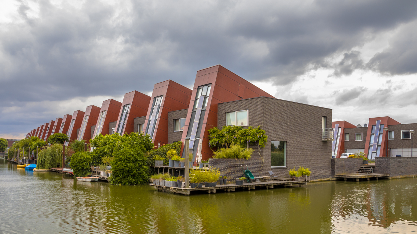 Ecological houses with integrated solar panels and hanging gardens on waterfront in urban area of The Hague, Netherlands