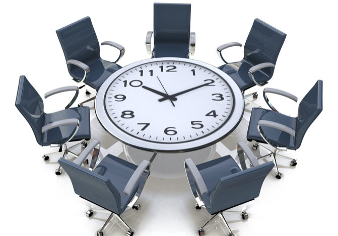 Meeting time - round table with a large clock face in the design of information related to business