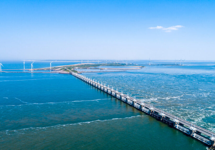 Oosterschelde flood barrier with windmills in the Netherlands at the Northern Sea taken from above with a drone